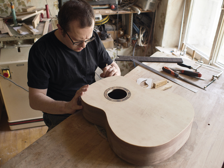 The process of making a cutaway on a classical guitar.の写真素材