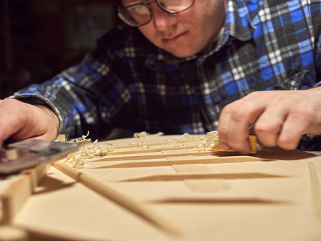 The process of making a classical guitar. Making the right shape of a brace guitar.