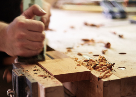 Production of classical guitar. Fitting the plane with the shape of the head of the neck.の写真素材