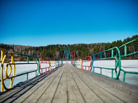 Cold Siberian landscape of a lake strained in the ice. frozen lake and the path to the diving tower.の写真素材