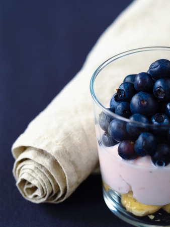 Homemade yogurt with banana and blueberries.の写真素材