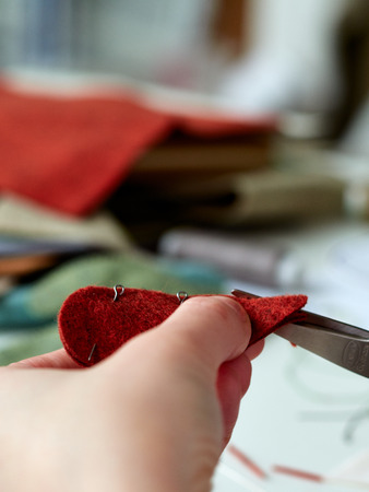 Step-by-step process of manual manufacturing baby crib mobile. Sewing a seam on a toy.の写真素材