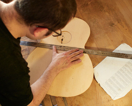 Marking and Pasting of footer and brace to the soundboard of a classical guitar. Production of classical guitar.の写真素材