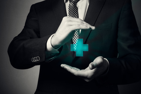 businessman hands closeup. a man in business suit shows caring gesture. life and health insurance.の写真素材