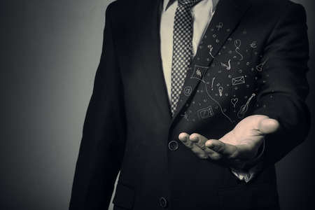 Businessman holding a cloud with dreams in his hand. Consumer credit.の写真素材