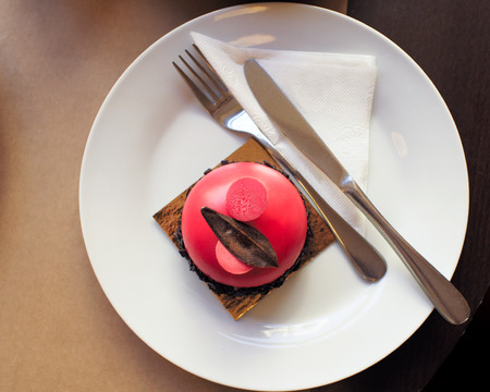 Pistachio sponge cake with raspberry mousse and chocolate-waffle crispy interlayer.の写真素材