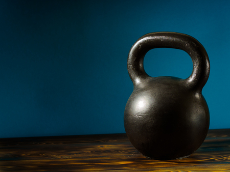 Weights on a wooden floor and blue background.の写真素材