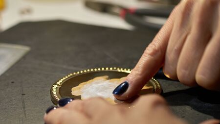 the engraver applies paste to the medal.の写真素材