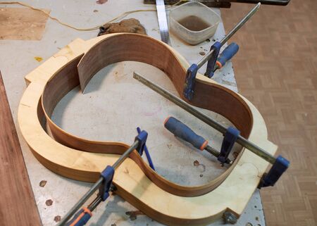 Shape shaping from rosewood for sides of classical guitar.