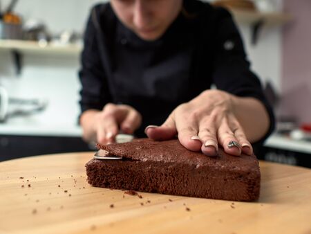 Step-by-step preparation of black designer cake.の写真素材