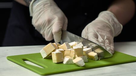 Step-by-step preparation of black designer cake. The confectioner prepares cream with cheese brie for cake.の写真素材