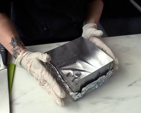 Step-by-step preparation of black designer cake. Preparation of a baking dish.