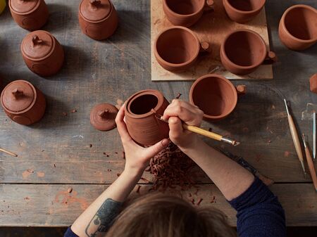 production process of pottery. applying a texture on the pottery.の写真素材