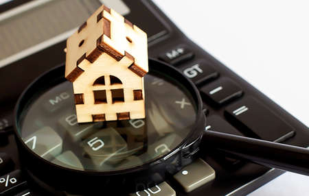 Miniature house on calculator background. Property, business conceptの写真素材