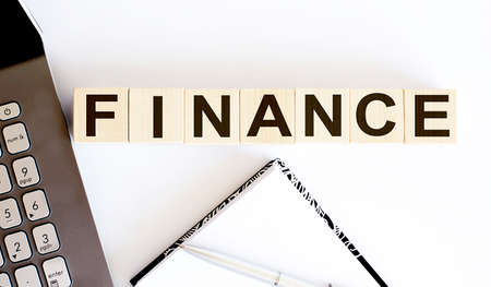 business concept text on wood block FINANCE on white backgroundの写真素材