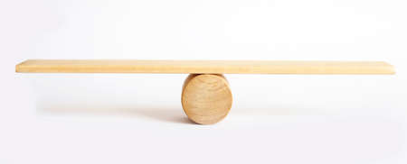 Balance concept, board on wooden top hat like balance isolated on white background.の写真素材