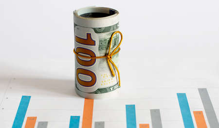 top view of business chart on white table with money