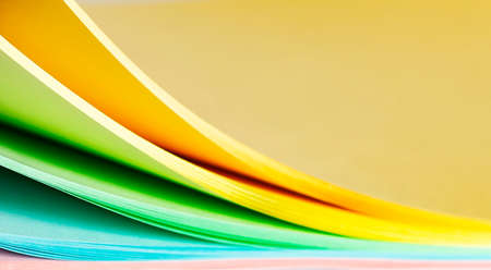 Sheets of multi-colored paper on a white background