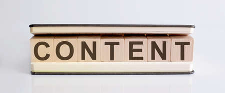 Text CONTENT is written on wooden building blocks on white background. Business concept.の写真素材