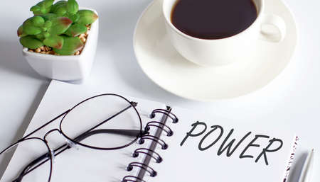 POWER text on notepad with glasses and cup of coffee