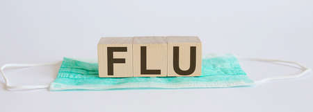 FLU medicine words on the wooden block. Healthcare conceptual for hospital, clinic and medical businessの写真素材