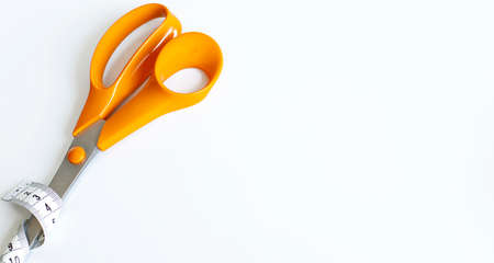 orange scissors, sewing objects on white background