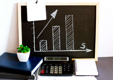 The graph shows the increase of the target drawn in chalk on Board with white sticker, calculator...