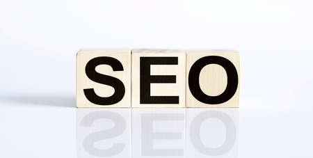 SEO - financial business concept on white background. Wooden cubes.