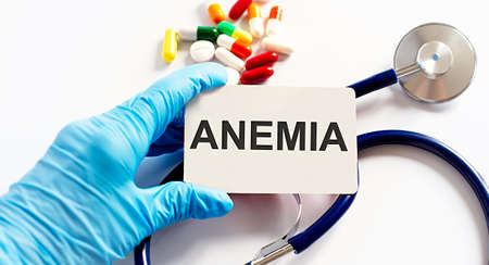 Card with text ANEMIA supplies, pills, stethoscope. Medical concept.の写真素材