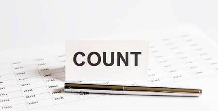 Text COUNT on stickers, pen on the background of documents. Financial bookkeeping, Accounting Concept. Top view.の写真素材