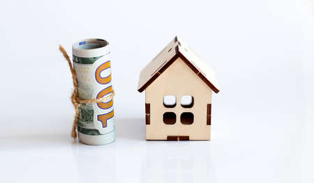 wooden house and dollar banknote. Image for property real estate investment concept.の写真素材