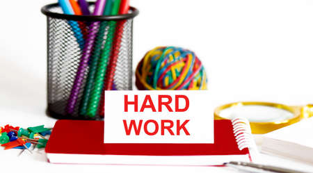 Word writing text HARD WORK on white stickers with office tools.Business concept.
