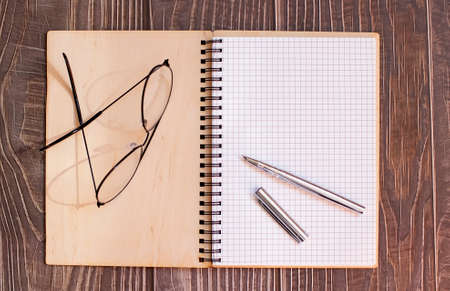 notebook and pen on wood backgroundの写真素材