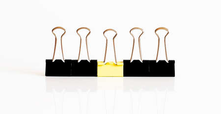 Business, office supplies, leadership, individuality or think different concept: yellow clip leader...