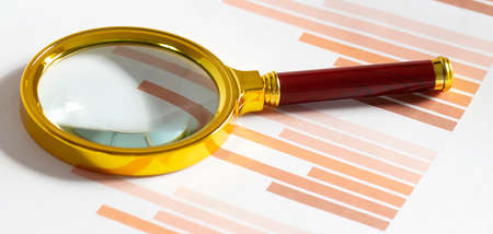 Business diagramme and magnifying glass, workplace businessmanの写真素材