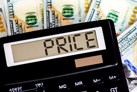 Calculator with text PRICE on dollars. Business, finance conceptual.の写真素材
