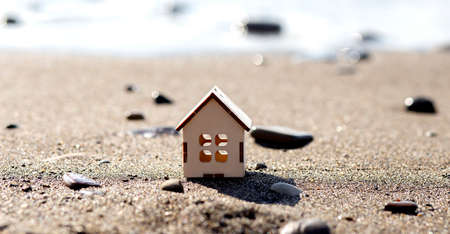 wooden house on the beach. Concept of mortgage.の写真素材