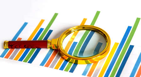 magnifying glass on the graph, business and financial conceptの写真素材
