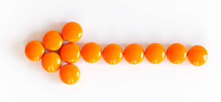 Orange pills, on the white background. Medical conceptの写真素材