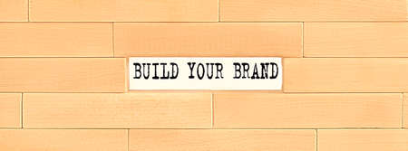 BUILD YOUR BRAND text on wooden block wall, businessの写真素材