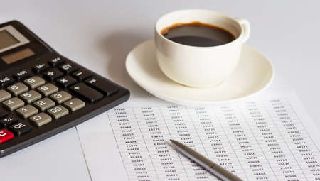 Calculator, pen with documents and coffee, business concept