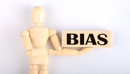 Wooden man shows with hand to block with text BIASの写真素材