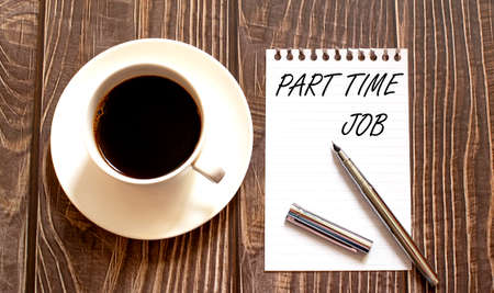PART TIME JOB - white paper with pen and coffee on the wooden backgroundの写真素材