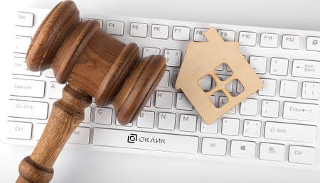 House Model With Gavel On keyboard on the white backgroundの写真素材