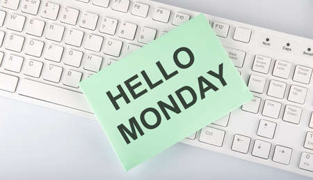 text HELLO MONDAY on a envelope on keyboard on the white backgroundの写真素材