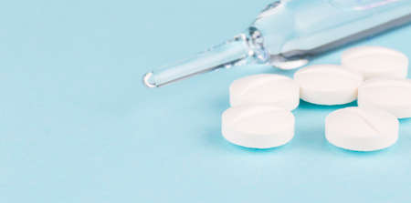 Medical ampoule, pils isolated on the blue background