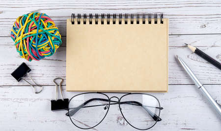Notebook and office supplies. View from above. Closeup on white background, copy space