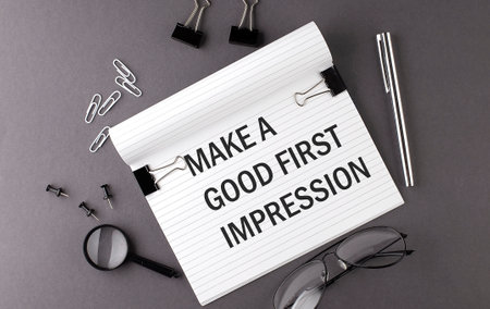 Notebook with Tools and Notes with text MAKE A GOOD FIRST IMPRESSION, businessの写真素材
