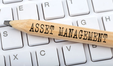 ASSET MANAGEMENT text on pencil on keyboard backgroundの写真素材