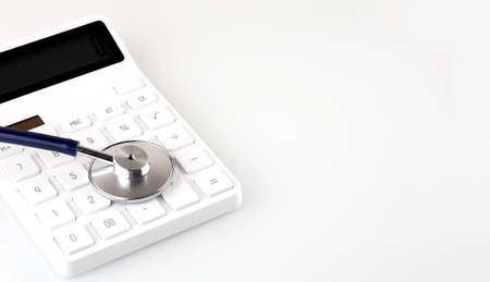 Stethoscope and calculator on the white background, copy space for textの写真素材